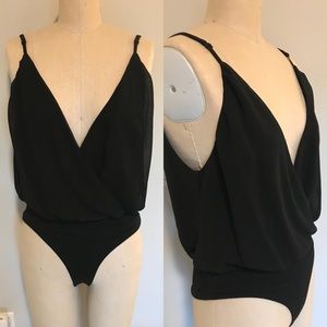 Used. Black sleeveless. chiffon body suit. Small